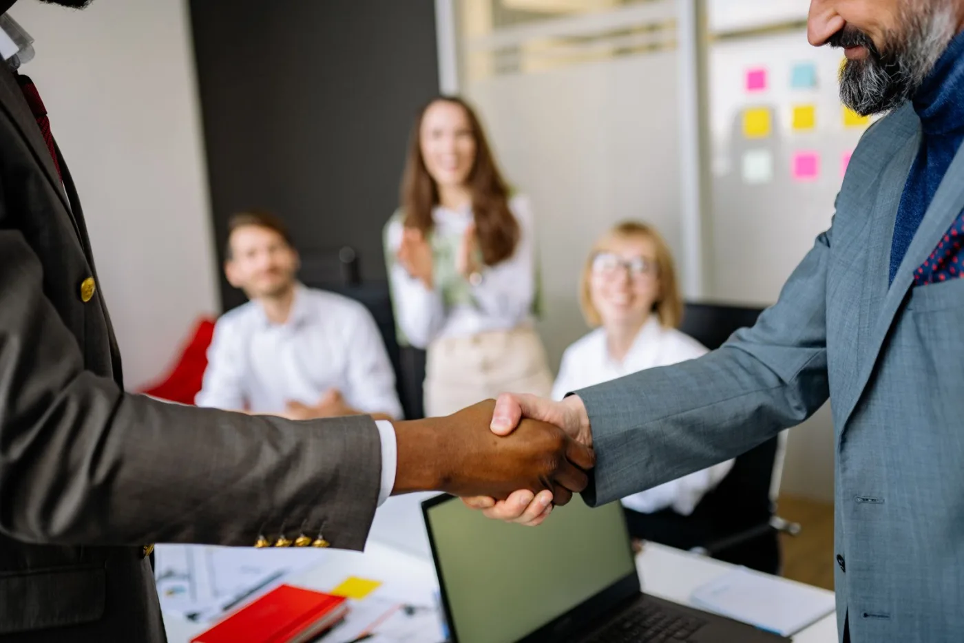 A handshake confirming an agreement at an industry meeting